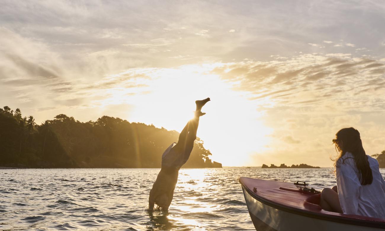 Man jumping off a boat into the sea